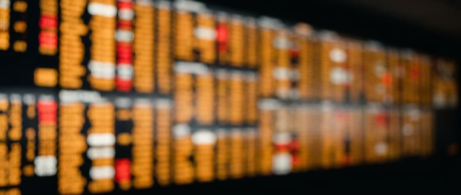 A wall of market-data screens thrown out of focus